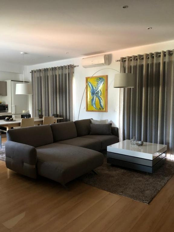 a living room with a couch and a table at Vanessa House Luxury Apartments in Skiathos Town