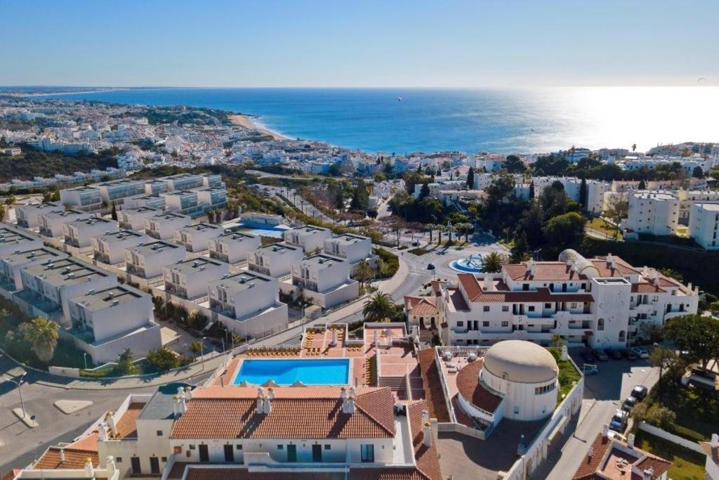 an aerial view of a city with houses and the ocean at Bellavista Jardim By BeGuest in Albufeira