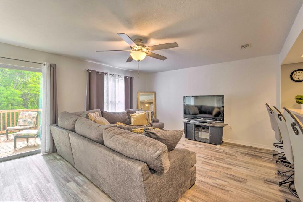 a living room with a couch and a flat screen tv at Updated Townhome with Deck about 12 Mi to Beaches! 