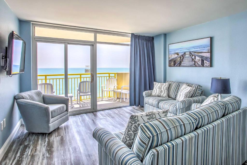 a living room with two couches and a balcony at Ocean-View Balcony: North Myrtle Beach Condo! in Myrtle Beach
