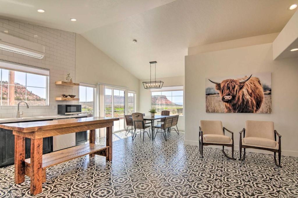a kitchen and dining room with a cow painting on the wall at Modern Ranch House with Fire Pit and Valley Views in Kanab