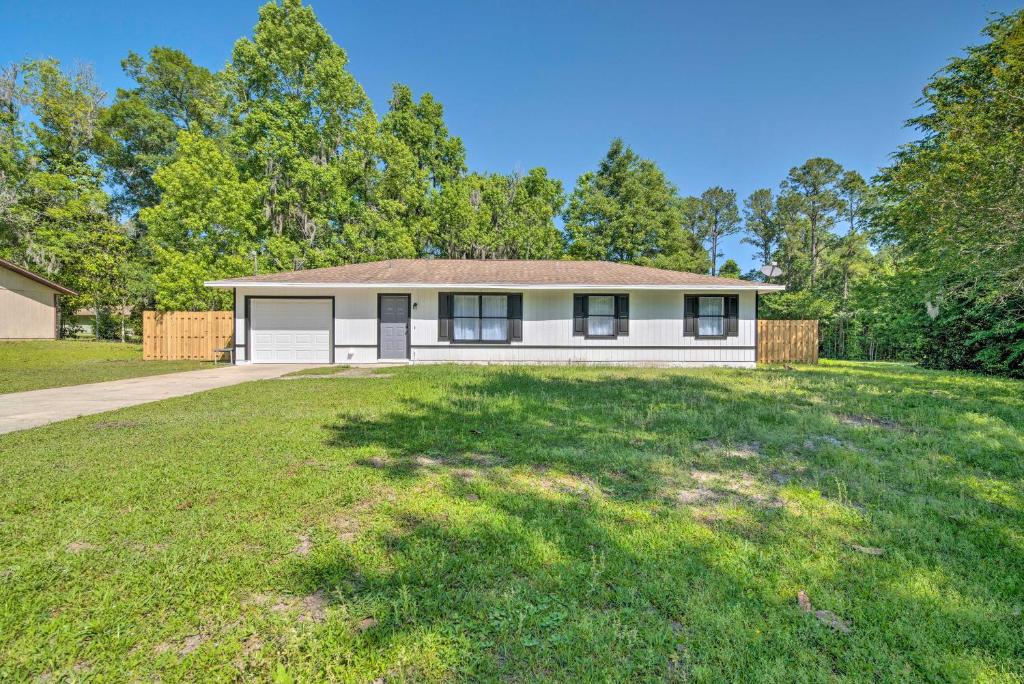 a house with a large yard in front of it at Cozy Retreat, 7 Mi to World Equestrian Center in Ocala