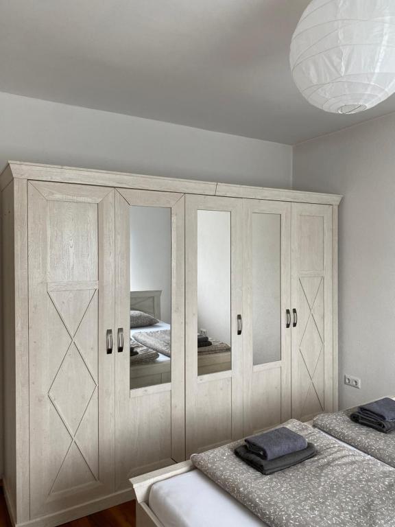 a bedroom with a large white cabinet with mirrors at Lena in Jajce
