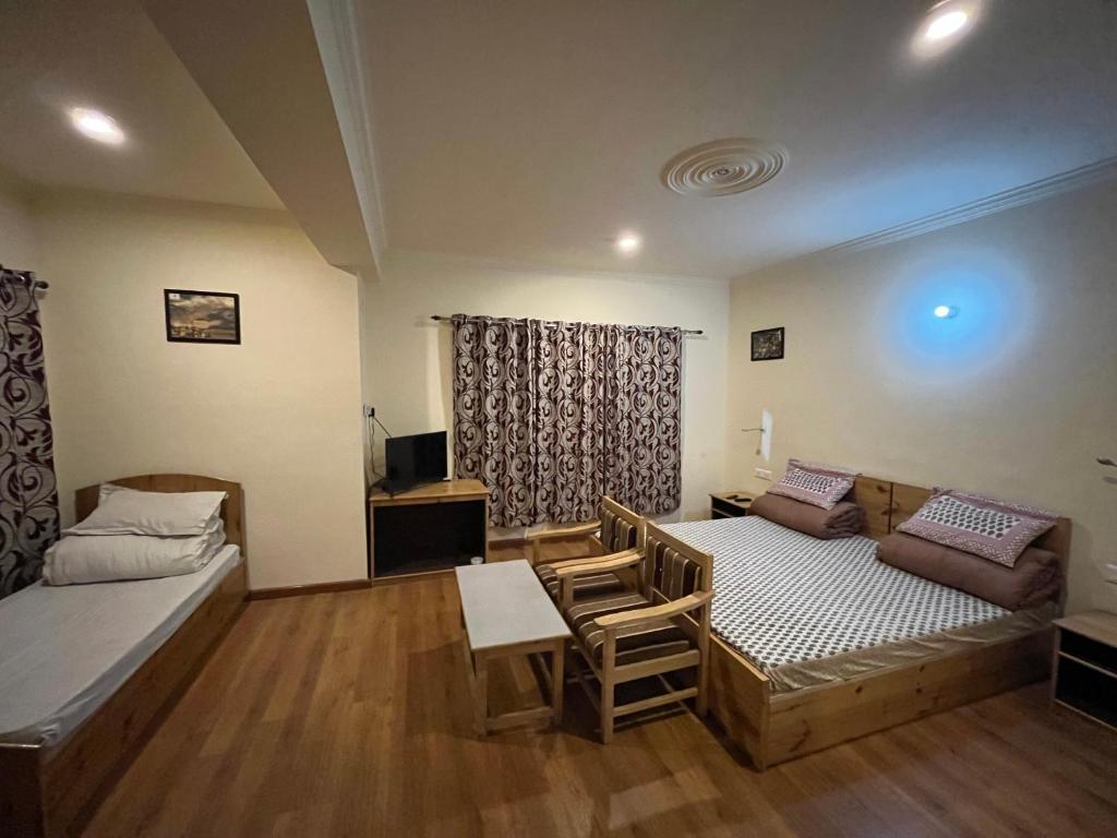 a living room with a bed and a couch at The Puma house in Leh