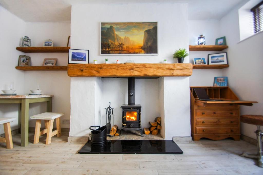 a fireplace in a room with a wood stove at Mermaid Cottage - Wood Burner- by Brighton Holiday Lets in Brighton & Hove