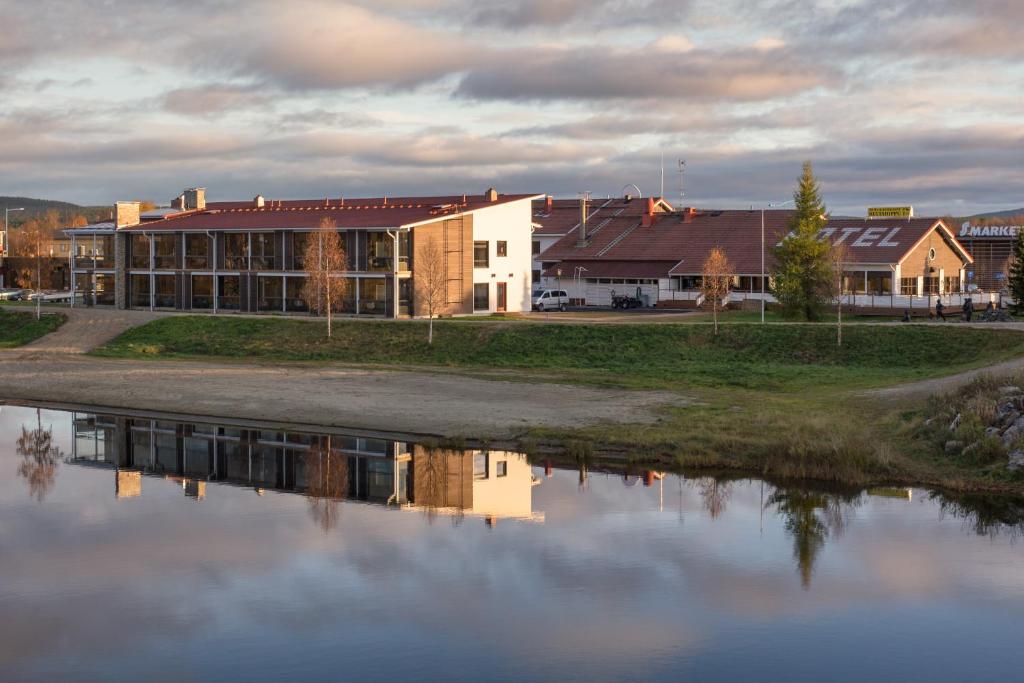 a building next to a body of water at Kultahippu Hotel & Apartments in Ivalo