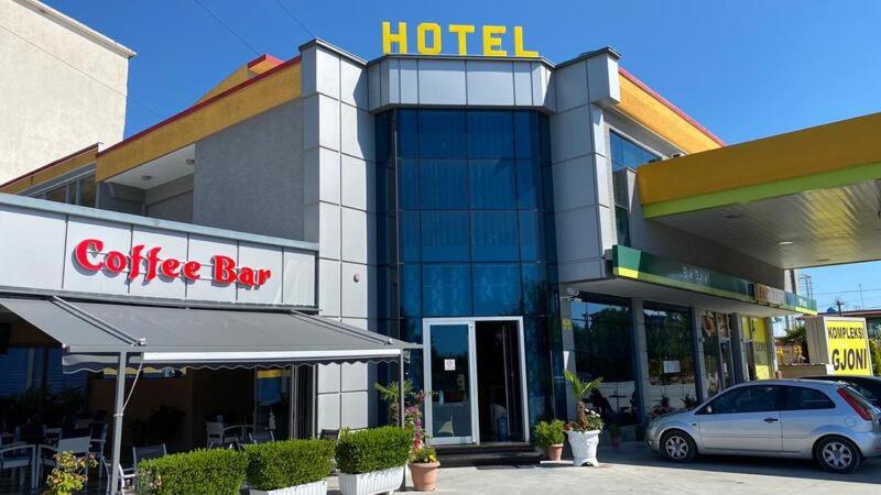 a hotel with a car parked in front of it at Kompleksi GJONI in Fier