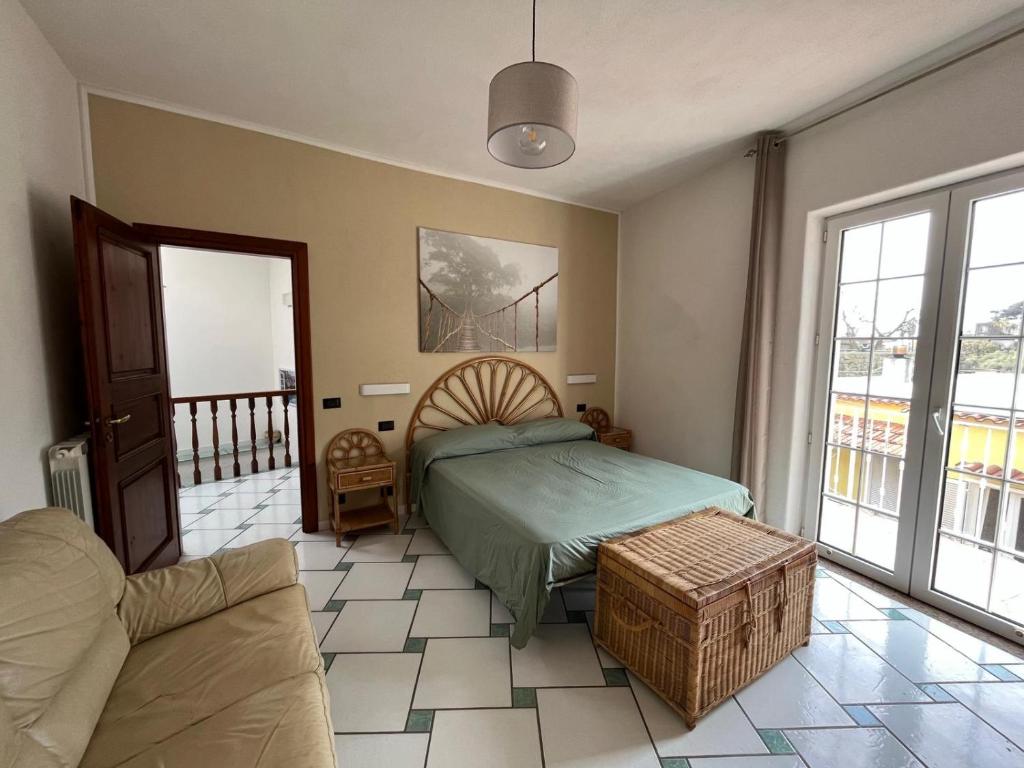 a bedroom with a bed and a couch at Casa Impagliazzo in Ischia