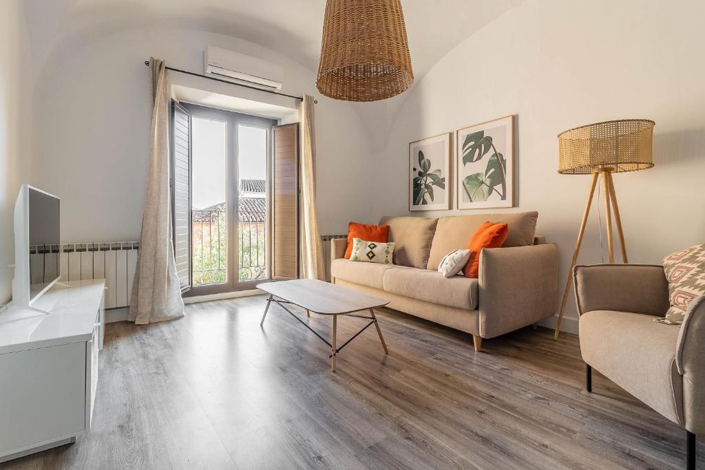 a living room with a couch and a table at Apartamentos El Patio de Santa Clara in Cáceres