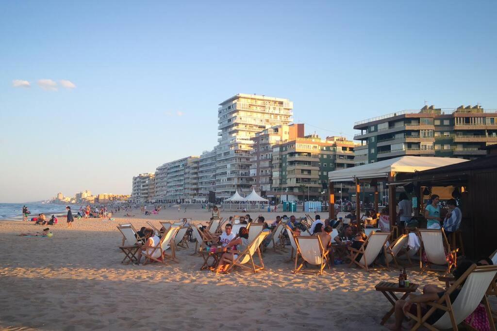 a group of people sitting in chairs on a beach at Cozy Apartment close to the beach in beatiful area in El Perelló