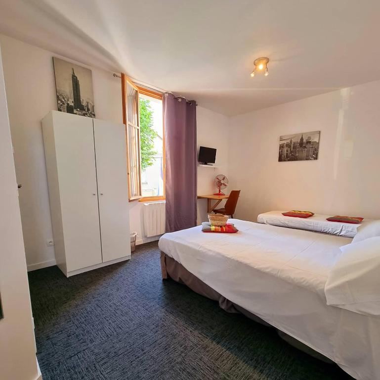 Posteľ alebo postele v izbe v ubytovaní Le Terminus