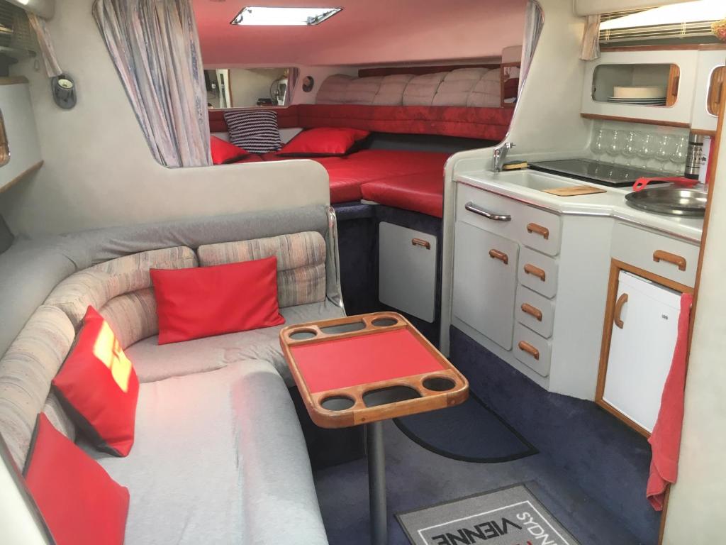 a interior view of an rv with a couch and a table at Location Bateau Hôtel Antibes in Antibes