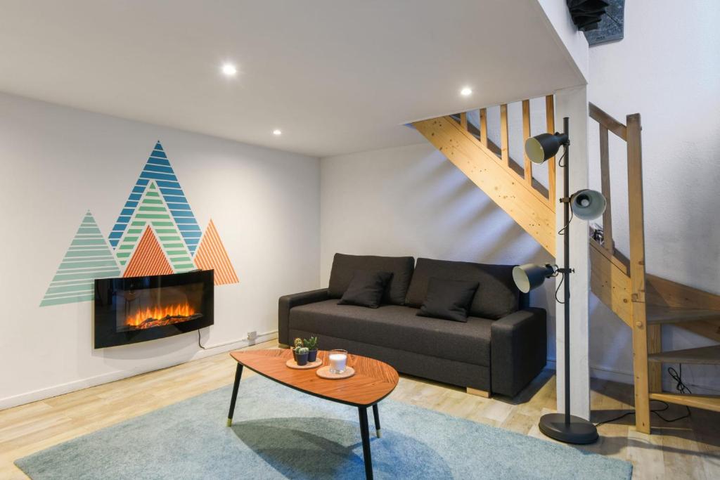a living room with a couch and a fireplace at Large and calm flat in the heart of Lille - Welkeys in Lille