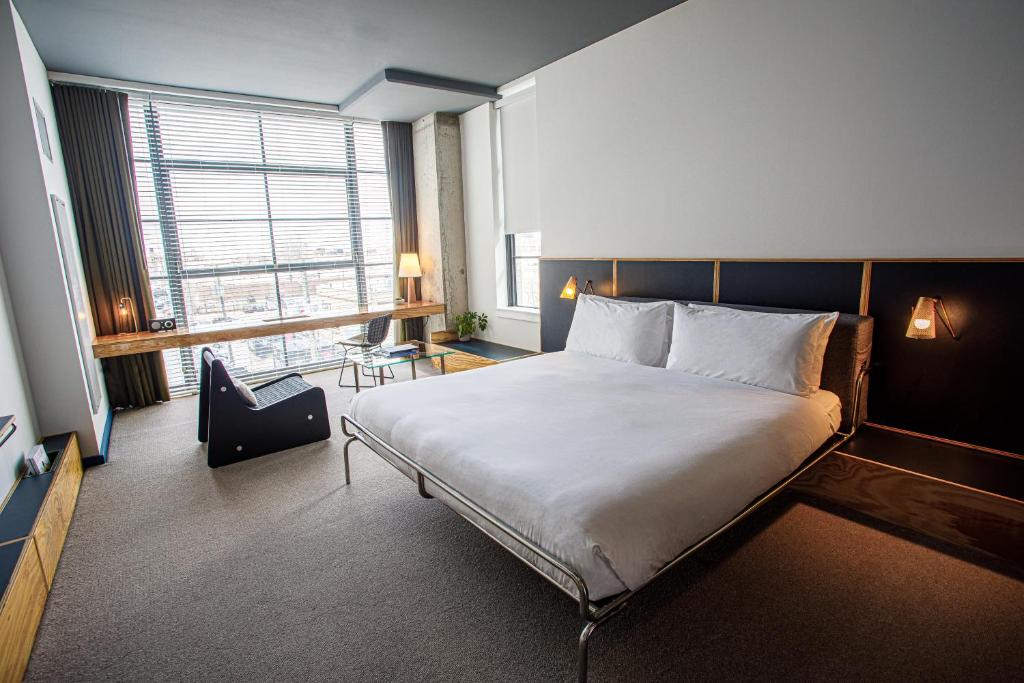 a bedroom with a large bed and a large window at The Emily Hotel in Chicago