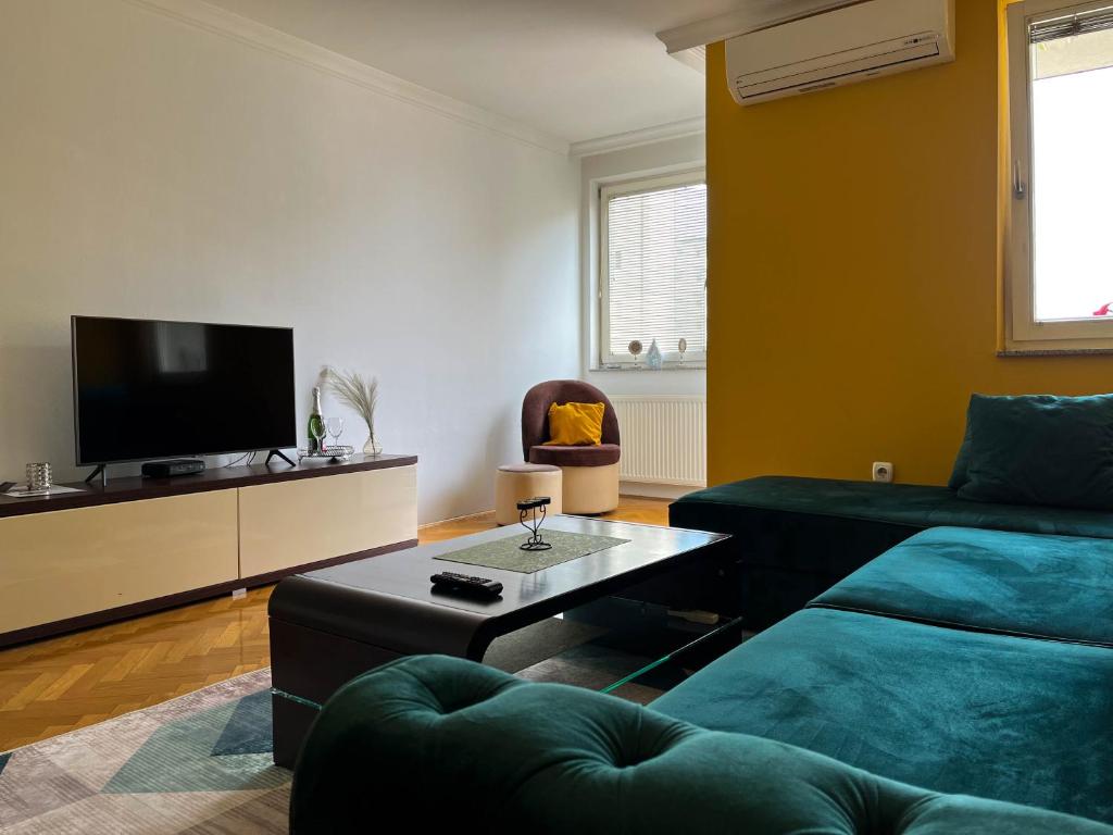 a living room with a couch and a coffee table at Apartman Ruby in Doboj