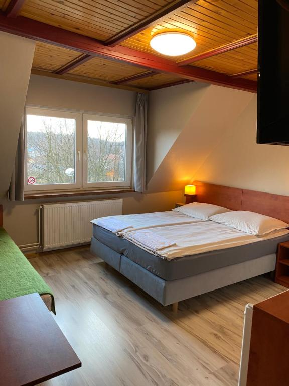 a bedroom with a large bed in a room at Gościniec BEATA in Łagów