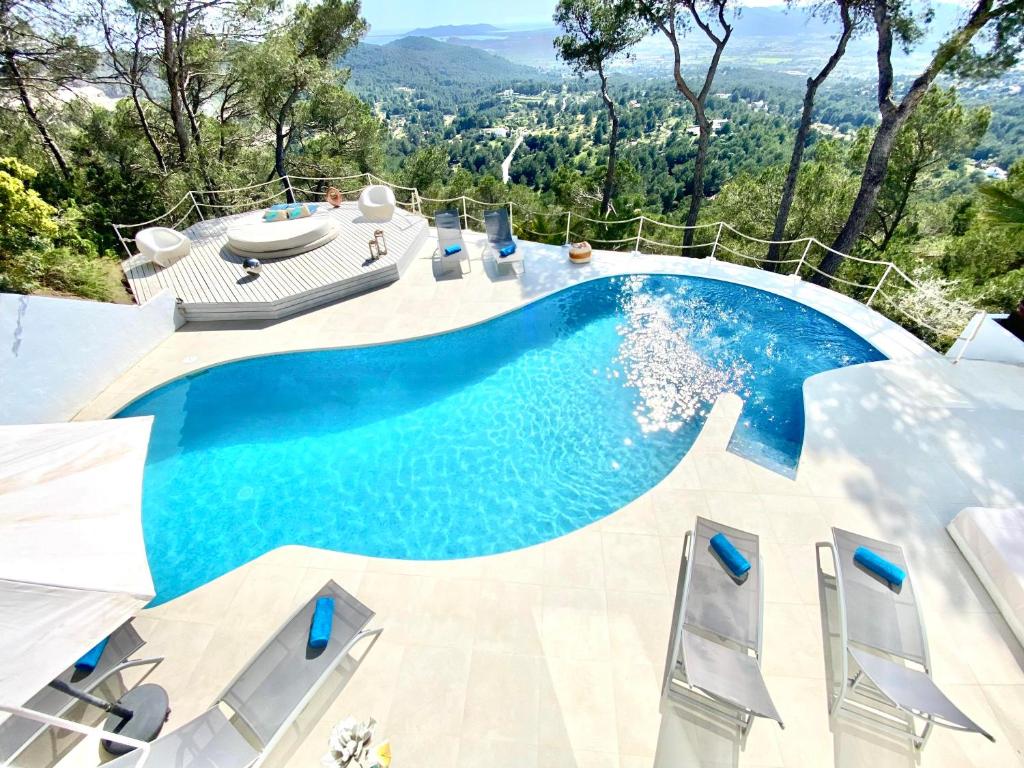 a swimming pool with a view of the mountains at Villa Tikal in Can Furnet