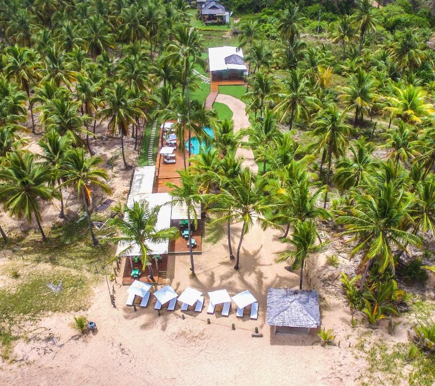 an aerial view of a resort with palm trees at Marauba Beach House - Taipu de Fora in Barra Grande