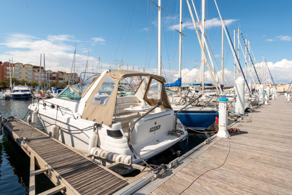 a group of boats docked at a dock at yacht vedette Arlequin in Gruissan