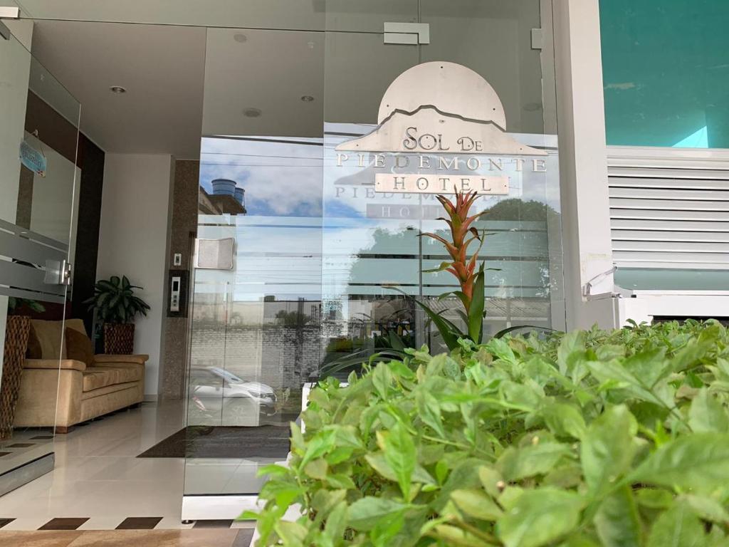 a building with a sign for a house with plants at Hotel Sol de Piedemonte in Yopal