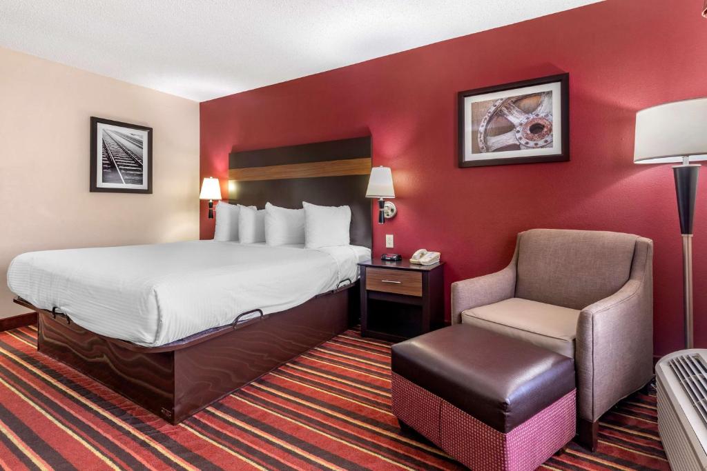 a hotel room with a bed and a chair at Best Western Lindale Inn in Lindale