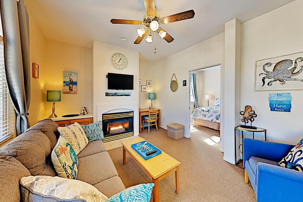 a living room with a couch and a fireplace at Pacific Plaza Resort Unit 108 in Oceano