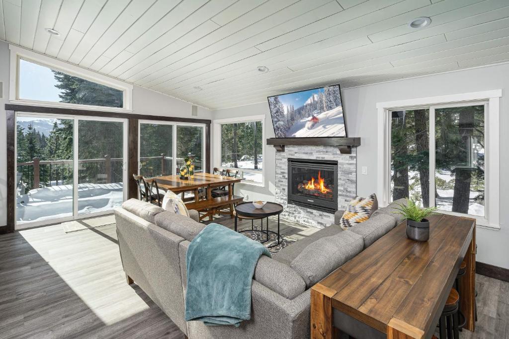 a living room with a couch and a fireplace at Tahoe Paradise Chalet in South Lake Tahoe