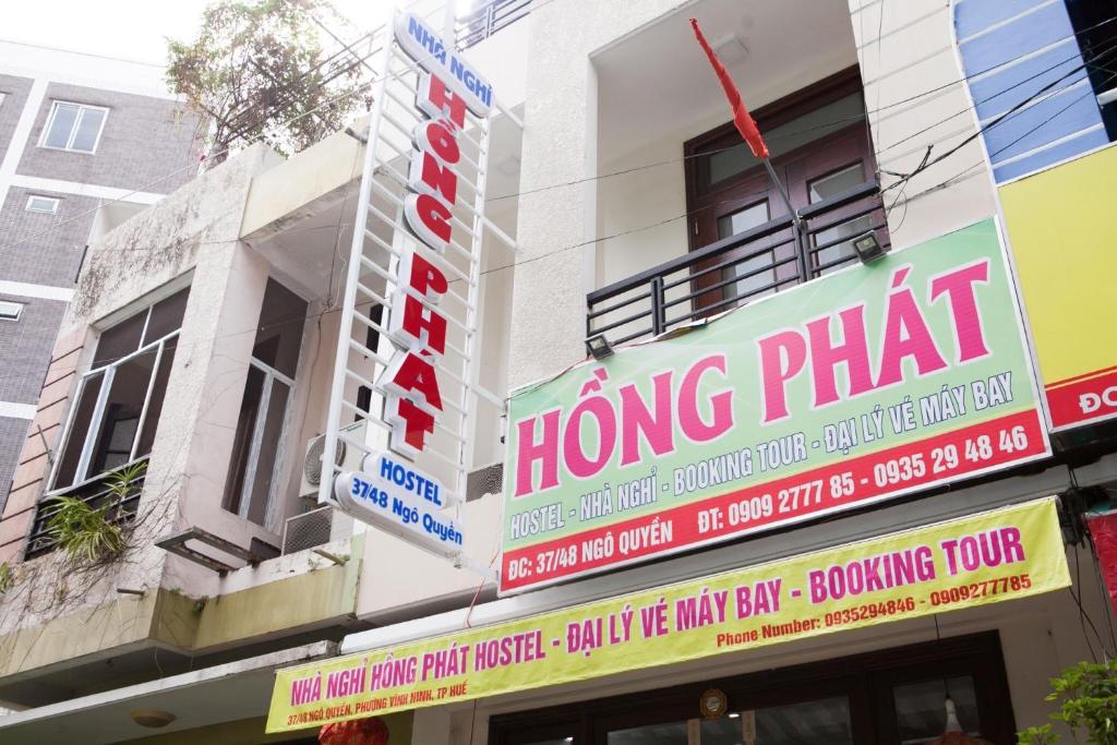 a sign for a hong pharmacy on the side of a building at Hồng Phát Hostel in Hue