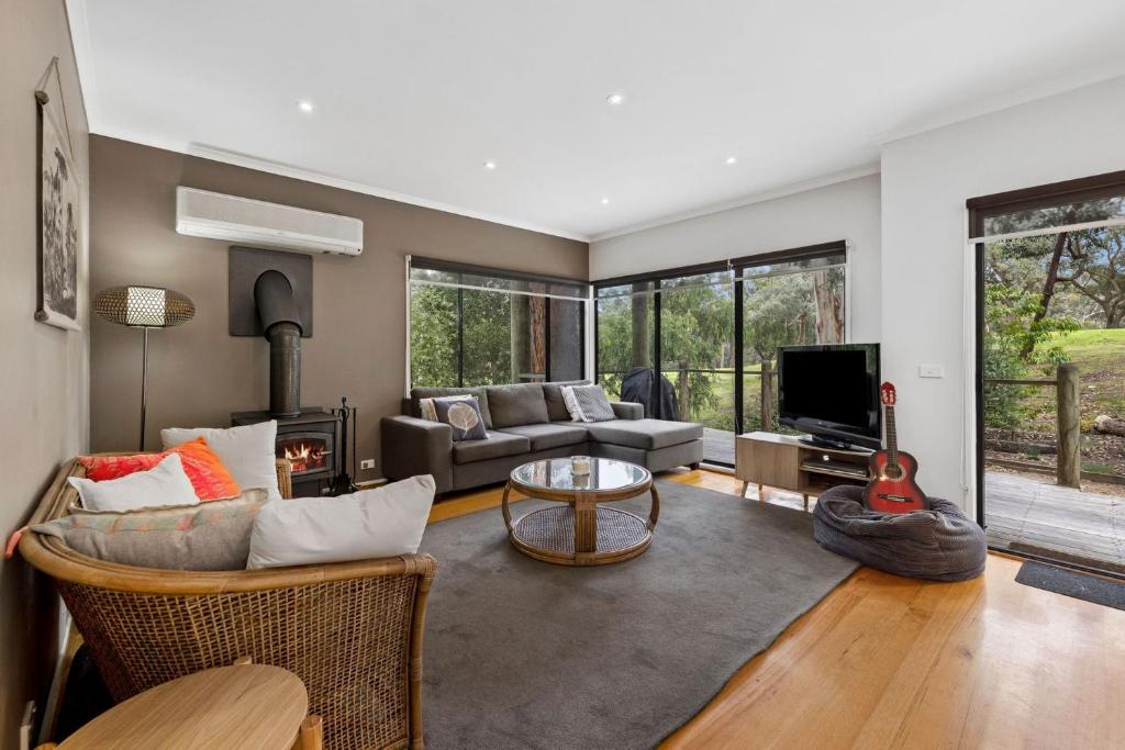 a living room with a couch and a fireplace at Hidden Gem in Lorne