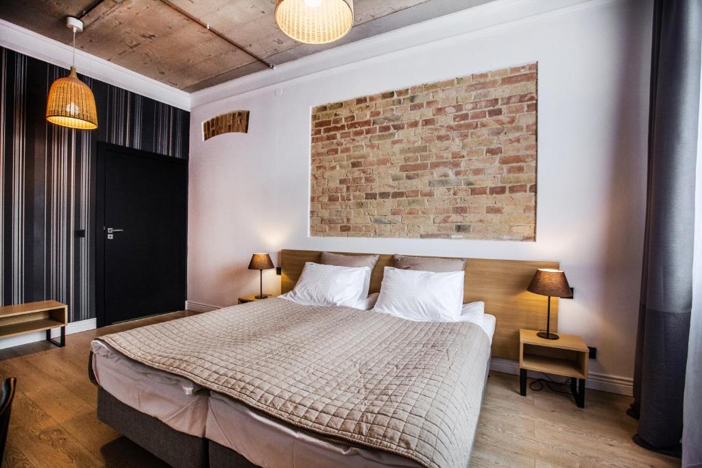 Postel nebo postele na pokoji v ubytování Qbatura Cafe & Hotel