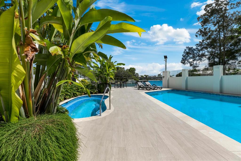 a swimming pool next to a resort with at Sun Lagoon Resort in Noosa Heads