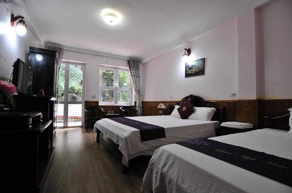 Postel nebo postele na pokoji v ubytování Ngan Nga Bac Ha Hotel
