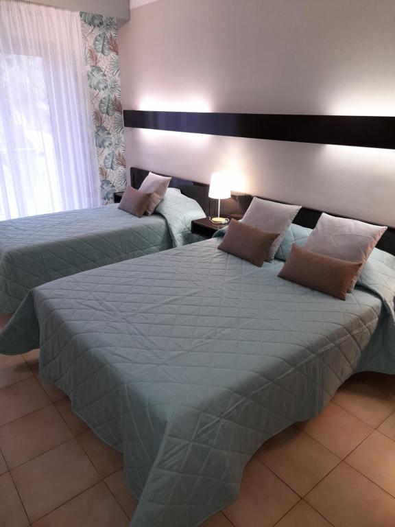 Postel nebo postele na pokoji v ubytování Hôtel Beach