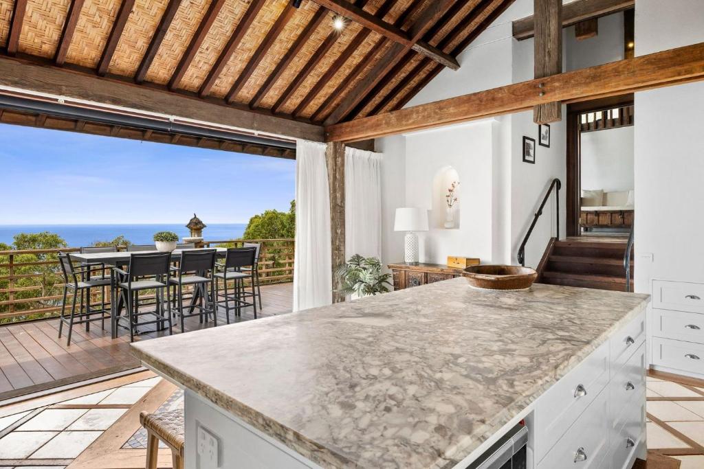 an open kitchen with a view of the ocean at Kilolo - Big Hill in Moggs Creek