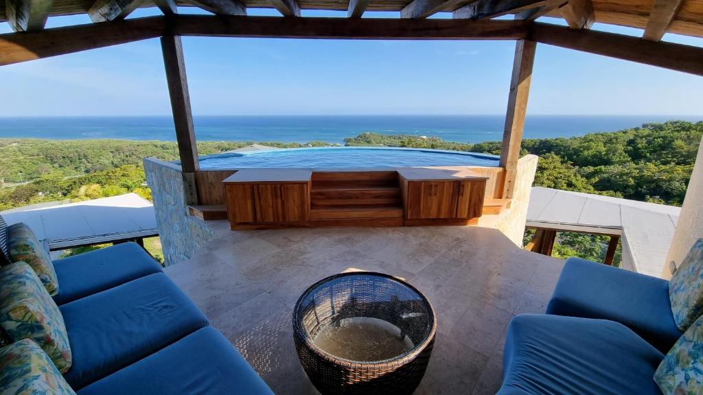 a view of a table and chairs on a balcony at VILLA ROA in Roatan