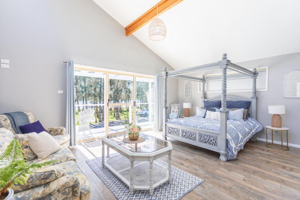 a bedroom with a bed and a couch at Fair Views in Sussex inlet