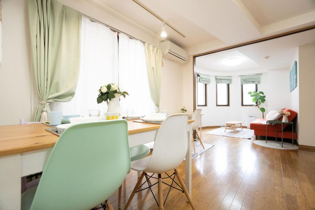 a kitchen and living room with a table and chairs at Elle's Shirokane Guest house in Tokyo