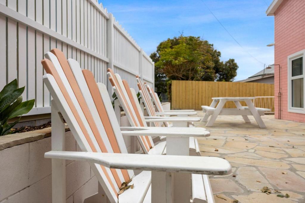 a row of chairs sitting on a patio at The Pink Lodge in Lorne