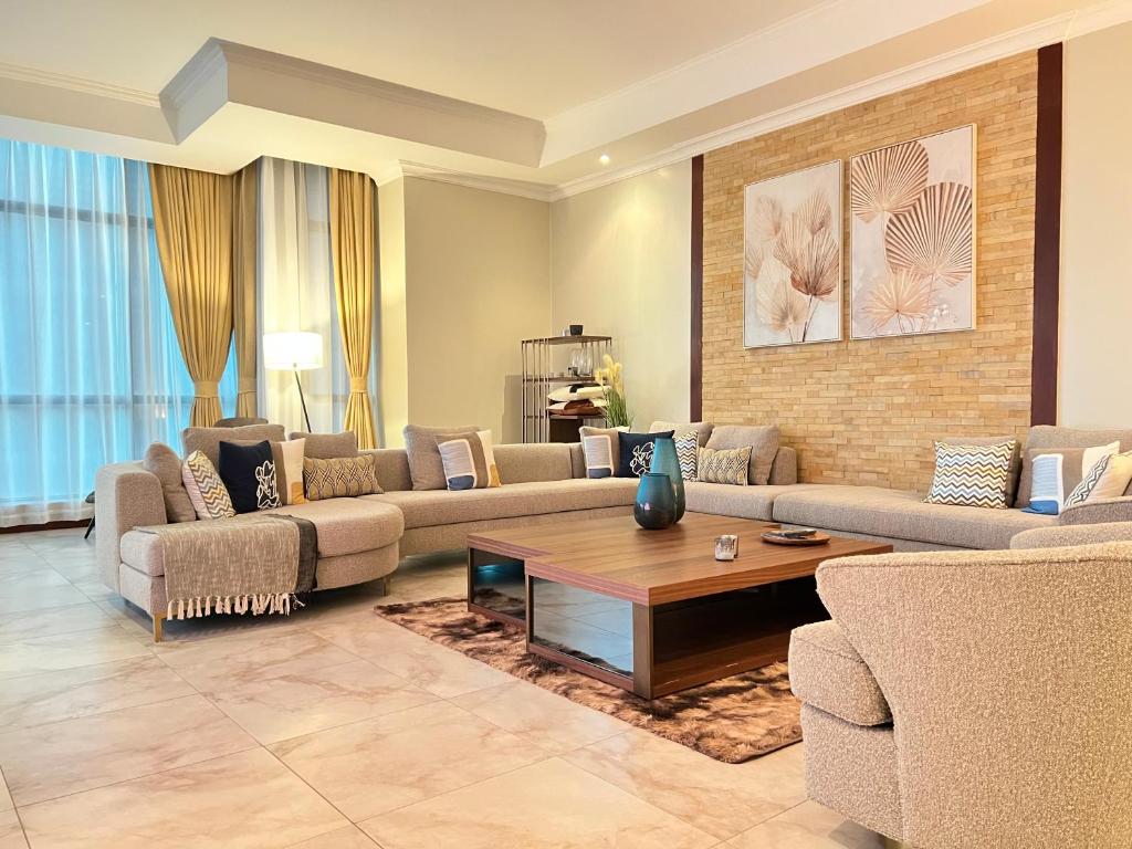 ein Wohnzimmer mit Sofas und einem Couchtisch in der Unterkunft Fairview Luxury Apartments in Daressalam