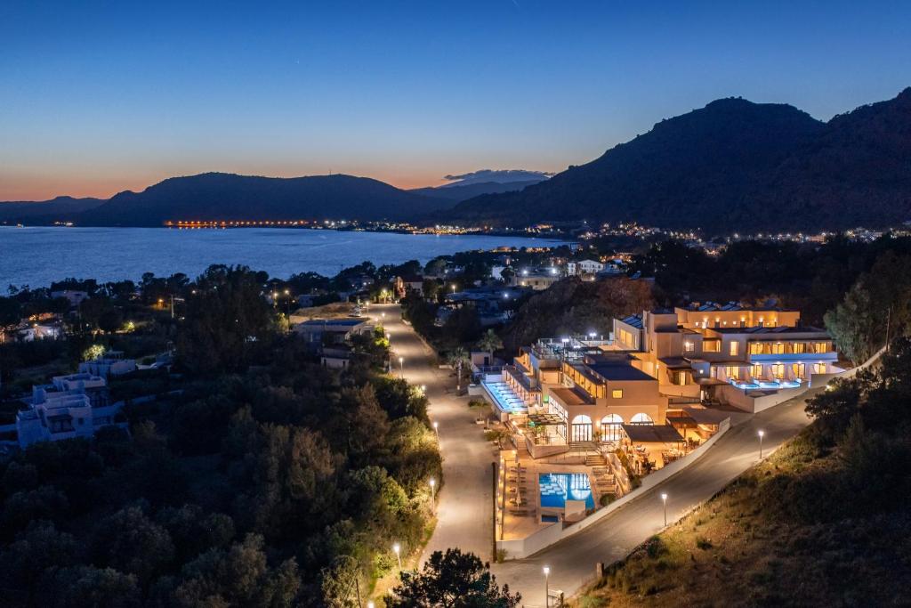 a view of a city at night with the water at Eagles Nest in Pefki Rhodes