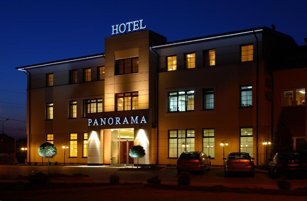 a hotel with cars parked outside of it at night at Hotel Panorama in Mszczonów