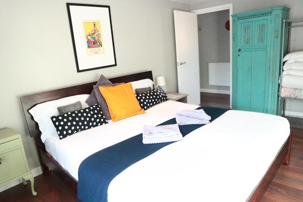 a bedroom with two beds and a blue cabinet at 147 knapp road house in London