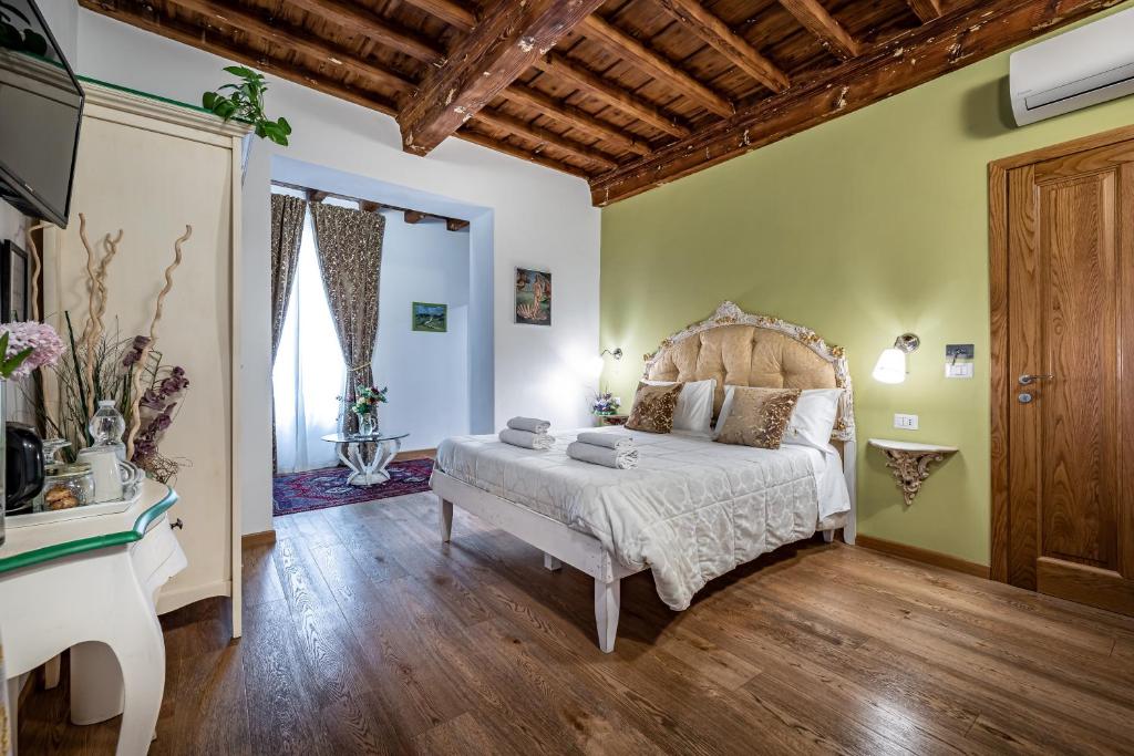a bedroom with a bed and a desk in a room at La Stella d'Oro B&B in Florence