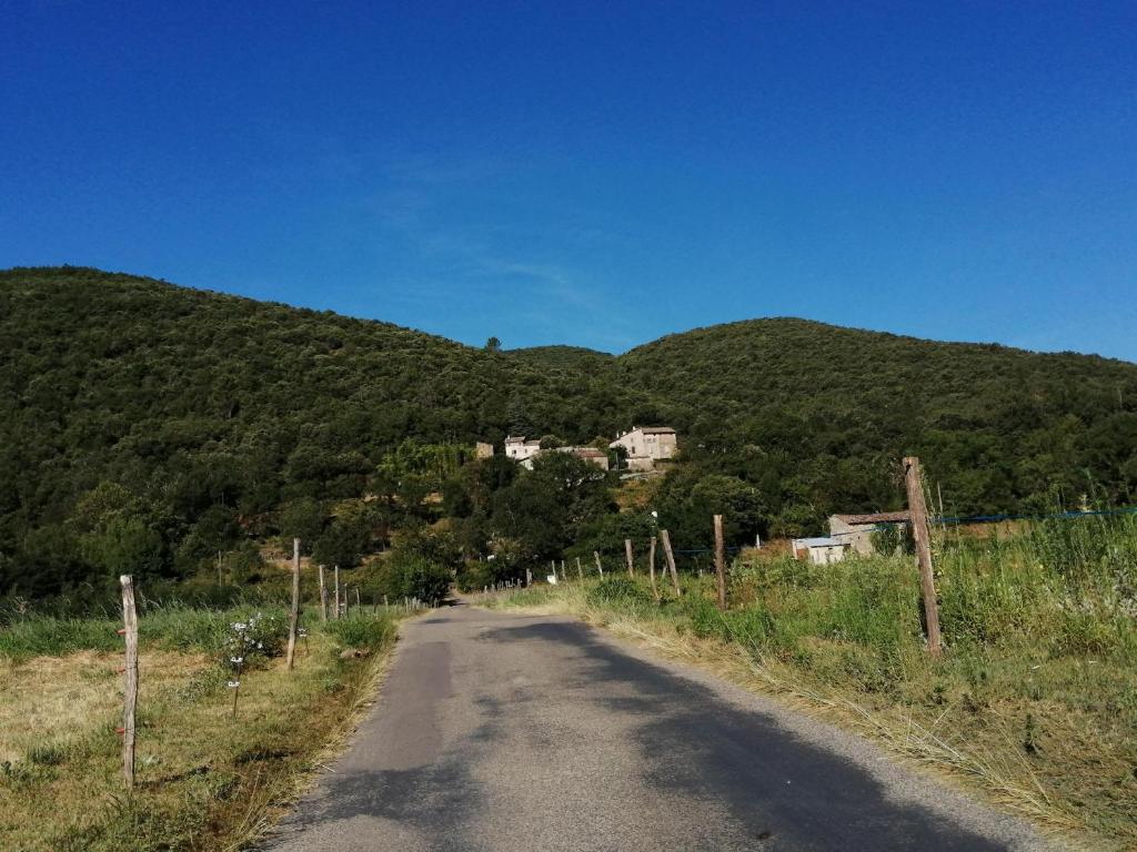 a dirt road in front of a mountain at Proche baignade, La Bergerie de Claire in Thoiras