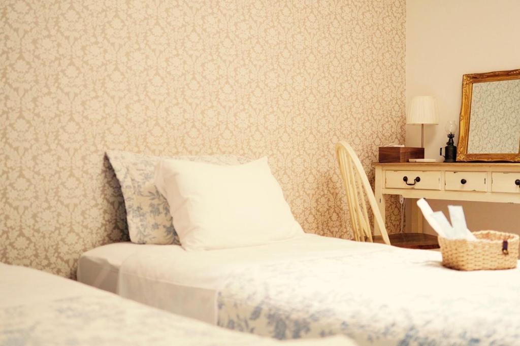 Postel nebo postele na pokoji v ubytování L'AtelieR Guest House Yonago