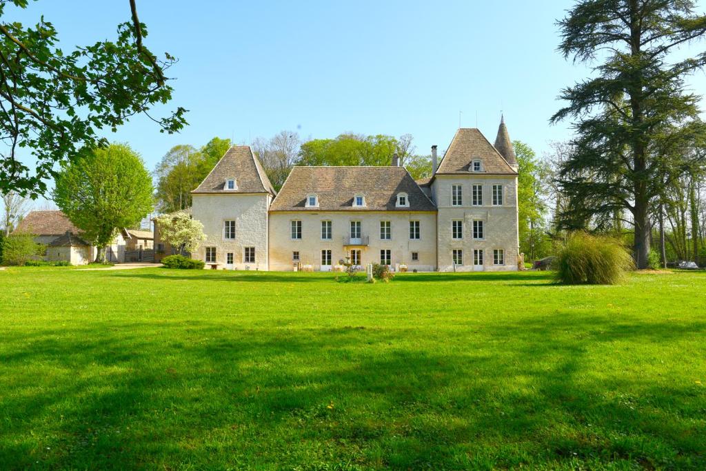 a large house with a large grass field at Château de Pymont in Boyer