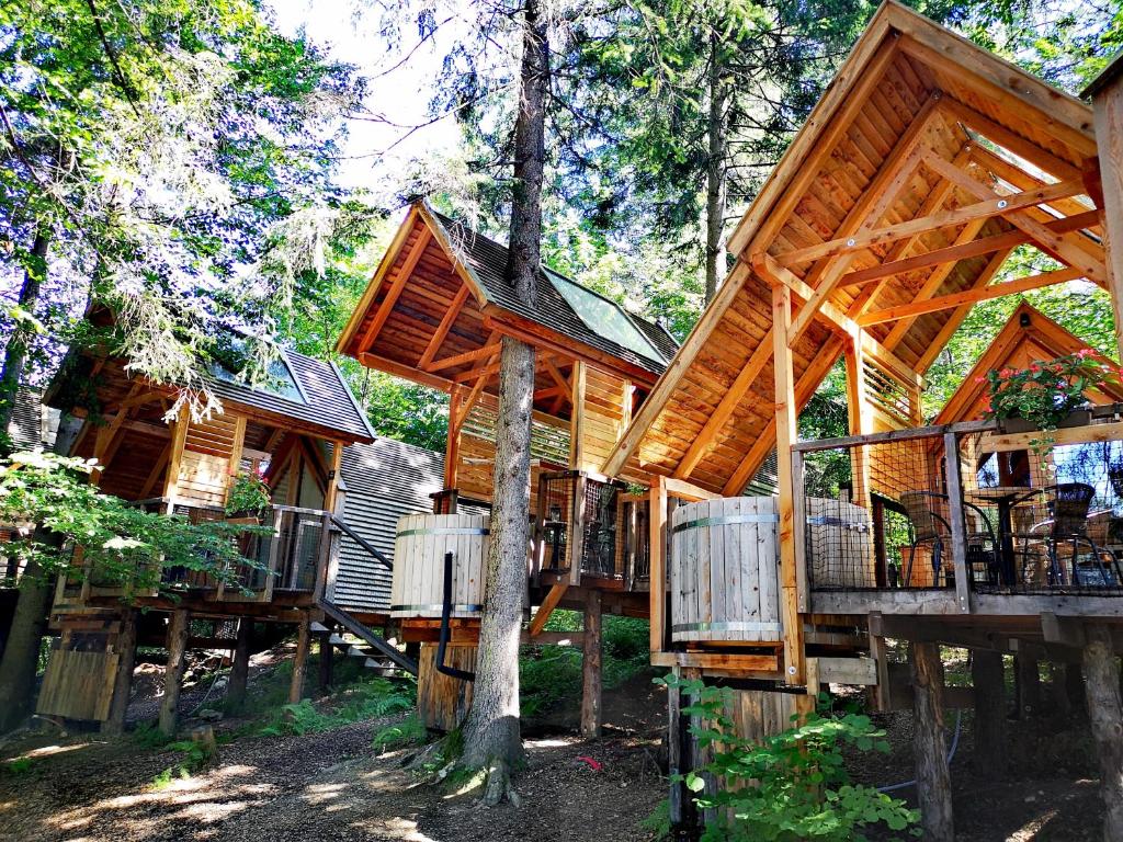 a large wooden house in the woods at Ribno Alpine Glamping in Bled