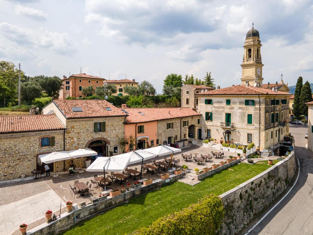 an overview of a town with a clock tower at Castrum Wine Relais in San Pietro in Cariano