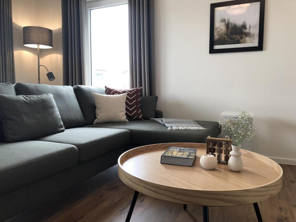 a living room with a couch and a coffee table at Sonnenweg 44-3 - HYGGE in Heringhausen