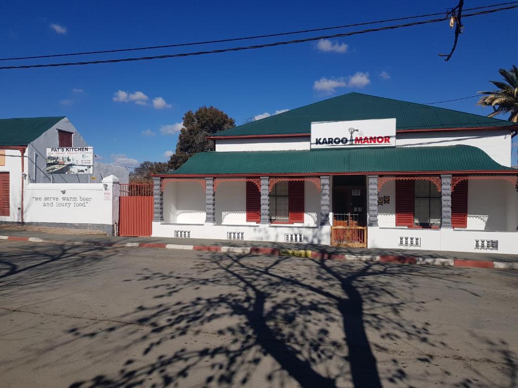 a building with a green roof on a street at Karoo Manor Guesthouse and Restaurant in Richmond